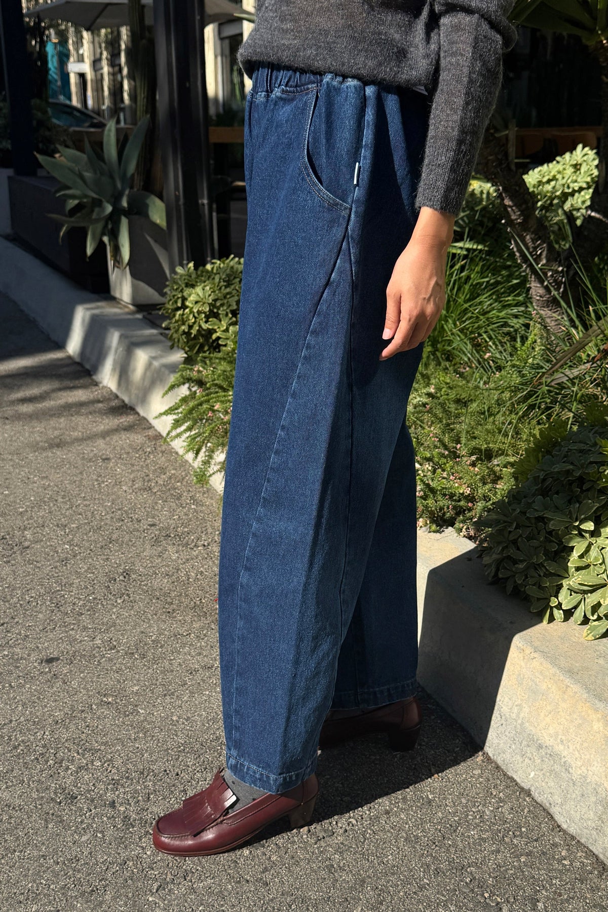 Model worn arc pants in blue denim