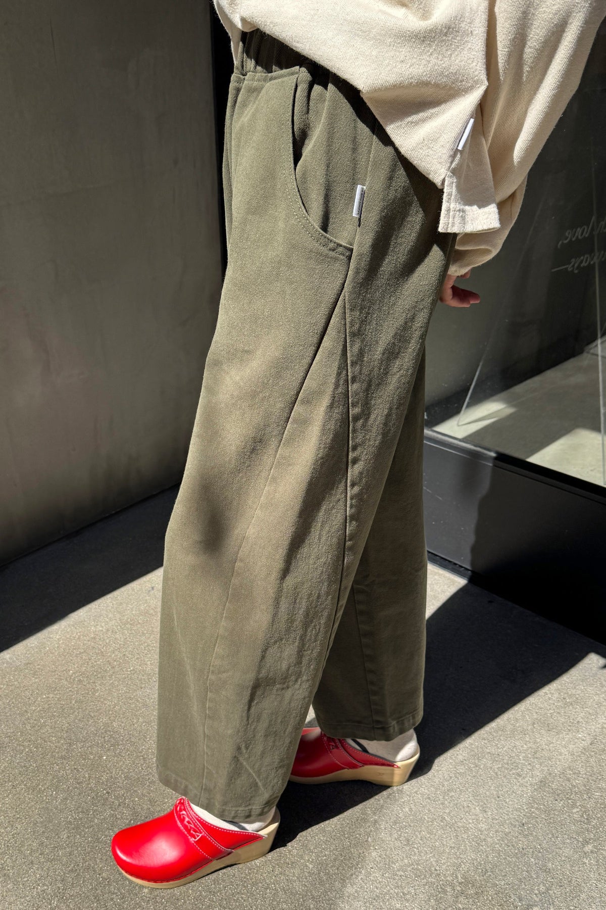 Model wearing olive green colored ardc pants