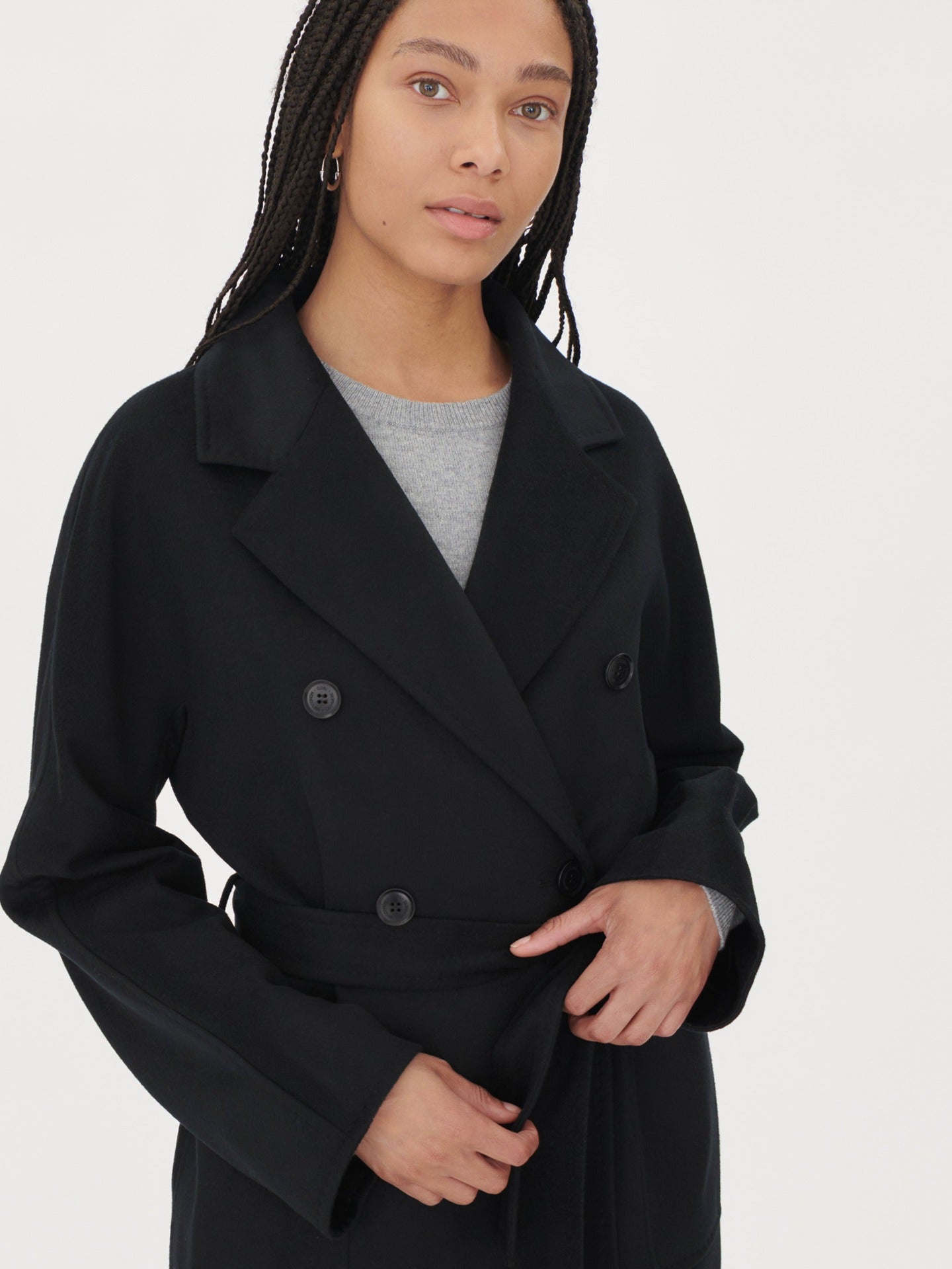 A model wearing a warm cashmere coat, styled with a belted waist for an elegant and cozy look.