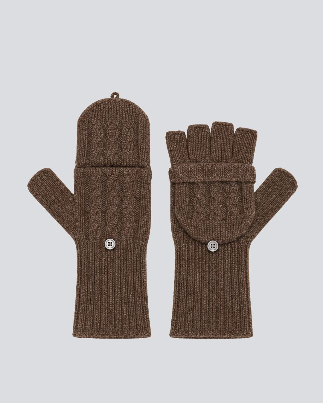 A pair of brown cable-knit fingerless gloves with a matching knit cuff and snap-button detail, displayed against a solid light gray background.