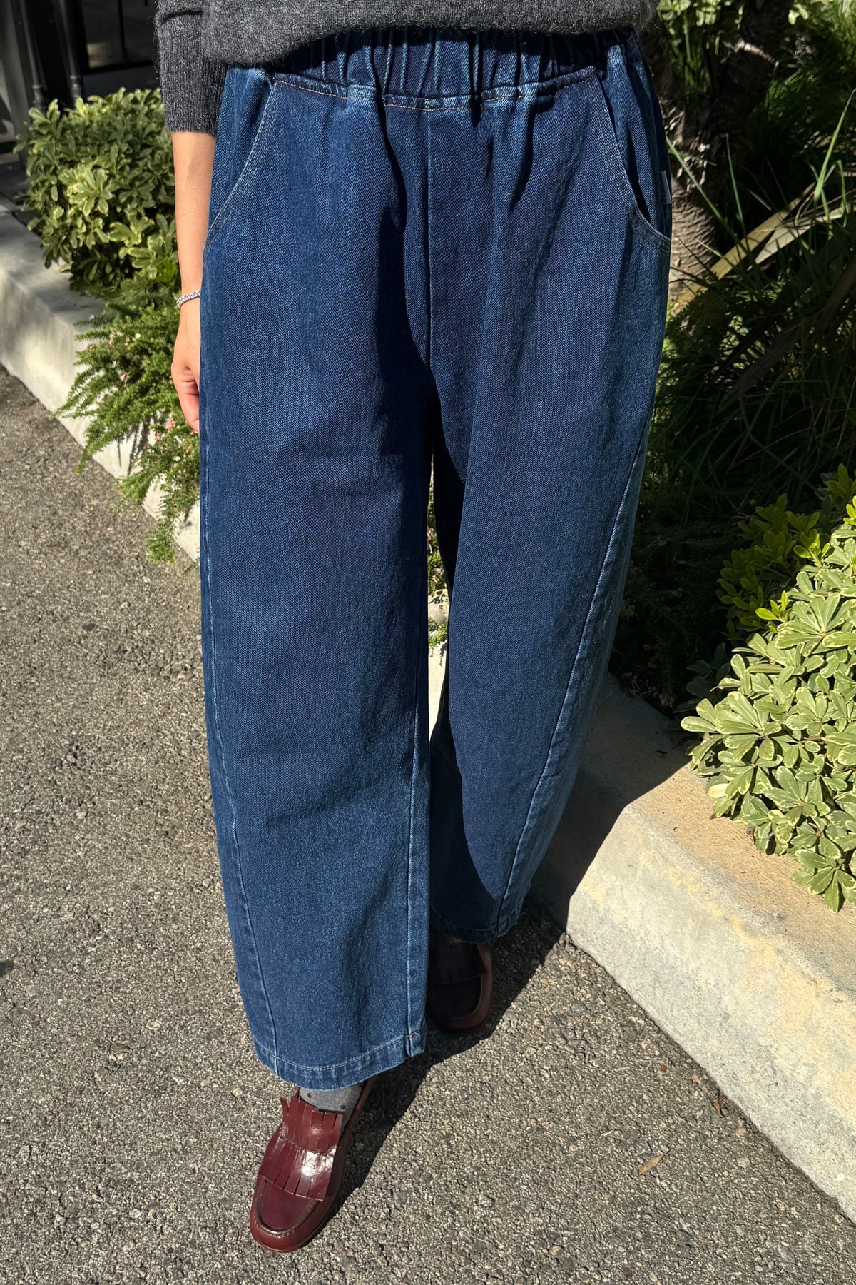 Model worn arc pants in blue denim
