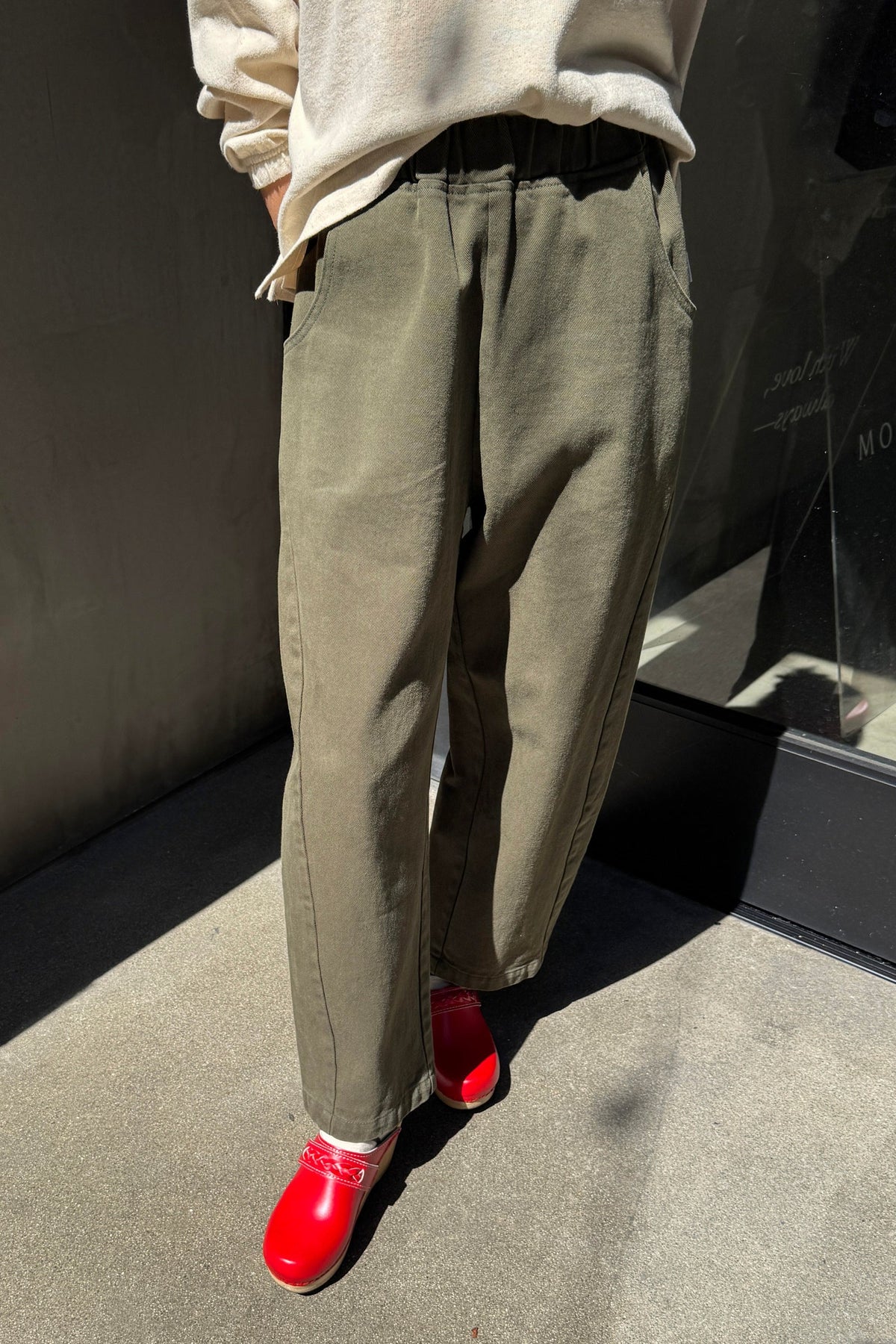 Model wearing olive green colored ardc pants
