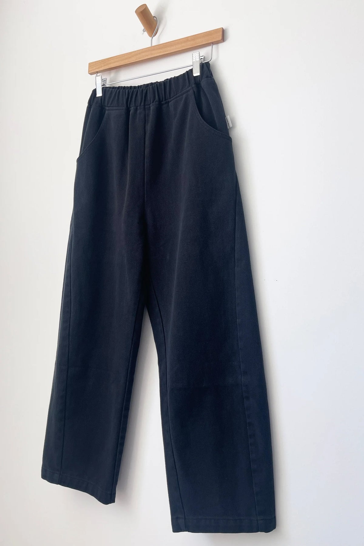 Arc pants in black canvas on hanger
