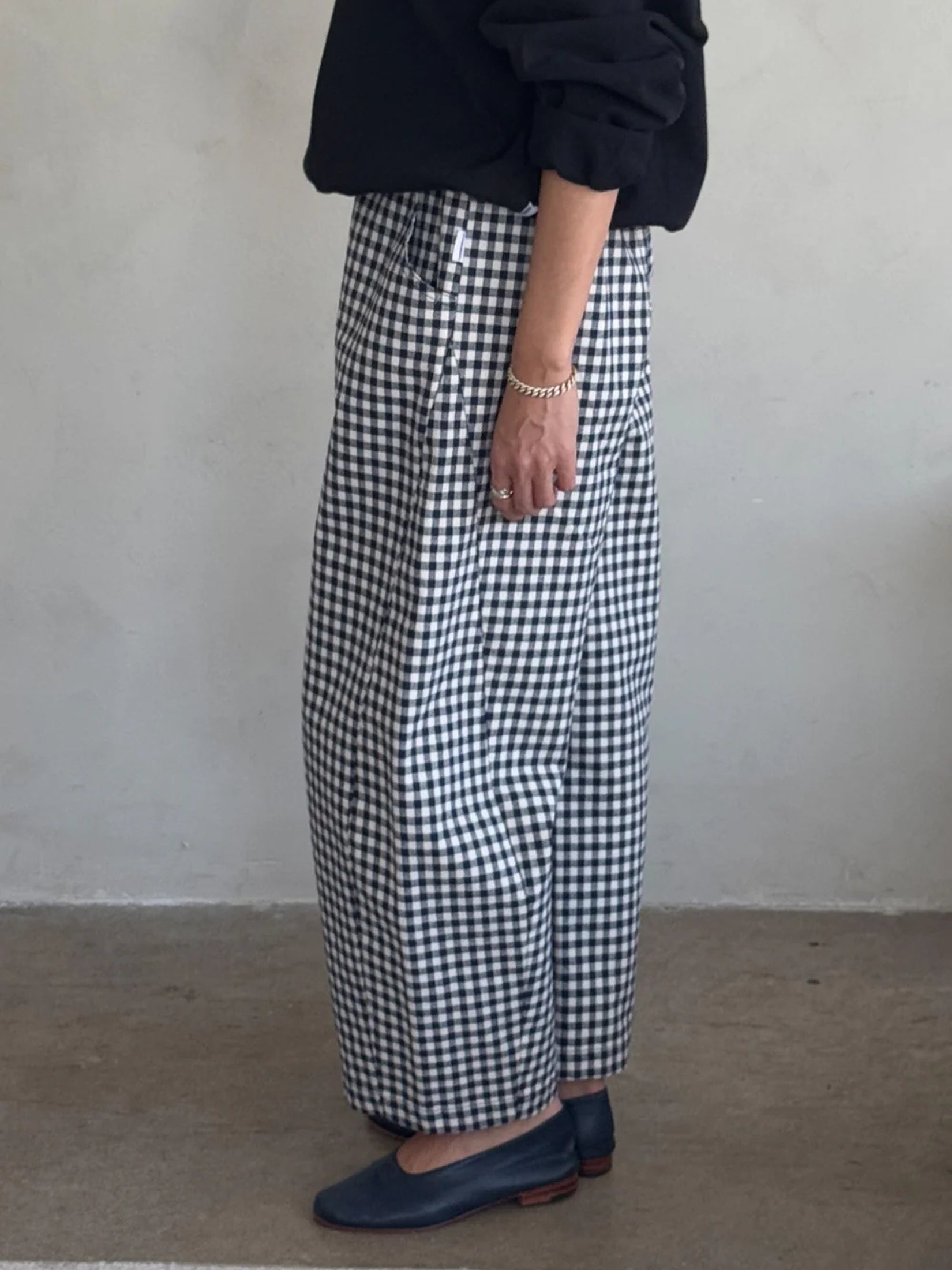 Model wearing navy gingham arc pants with a relaxed, contemporary fit.