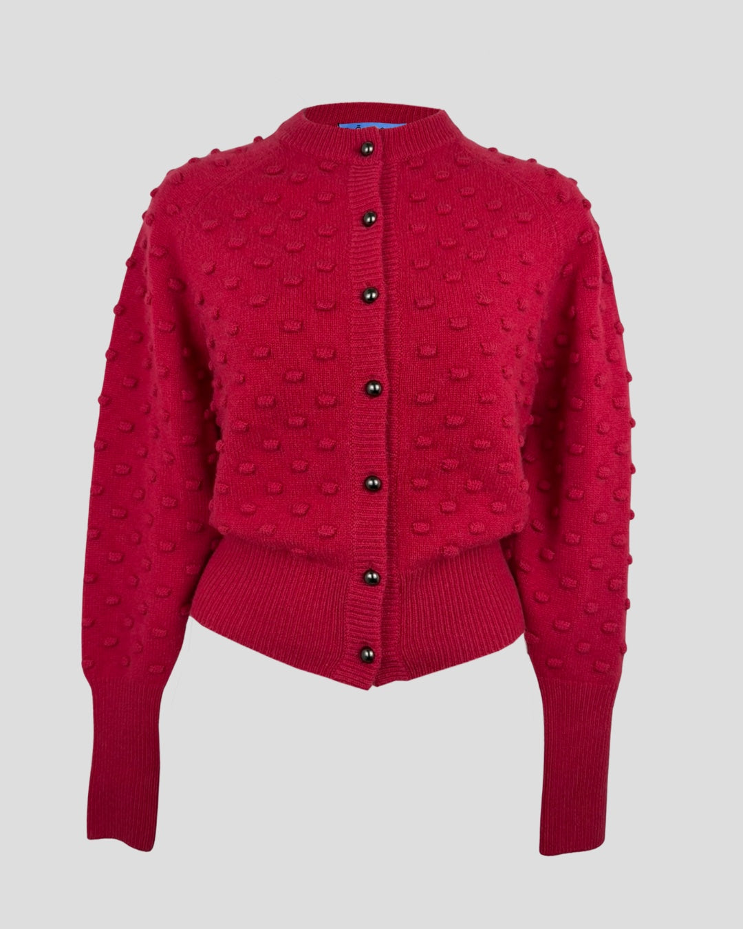 Red textured cashmere cardigan with a round neckline, button front, and long sleeves, photographed flat on a light background.
